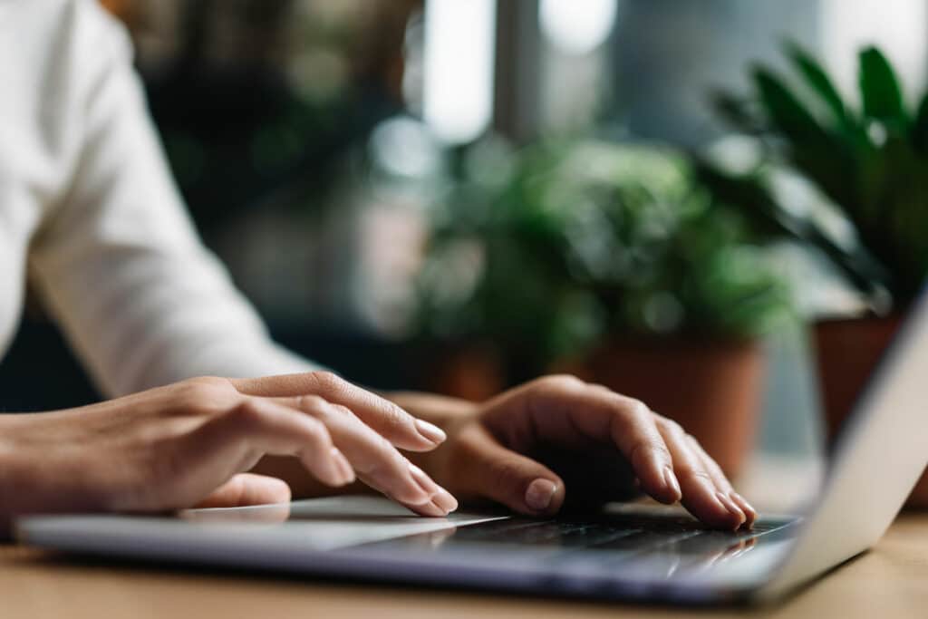 person typing on laptop